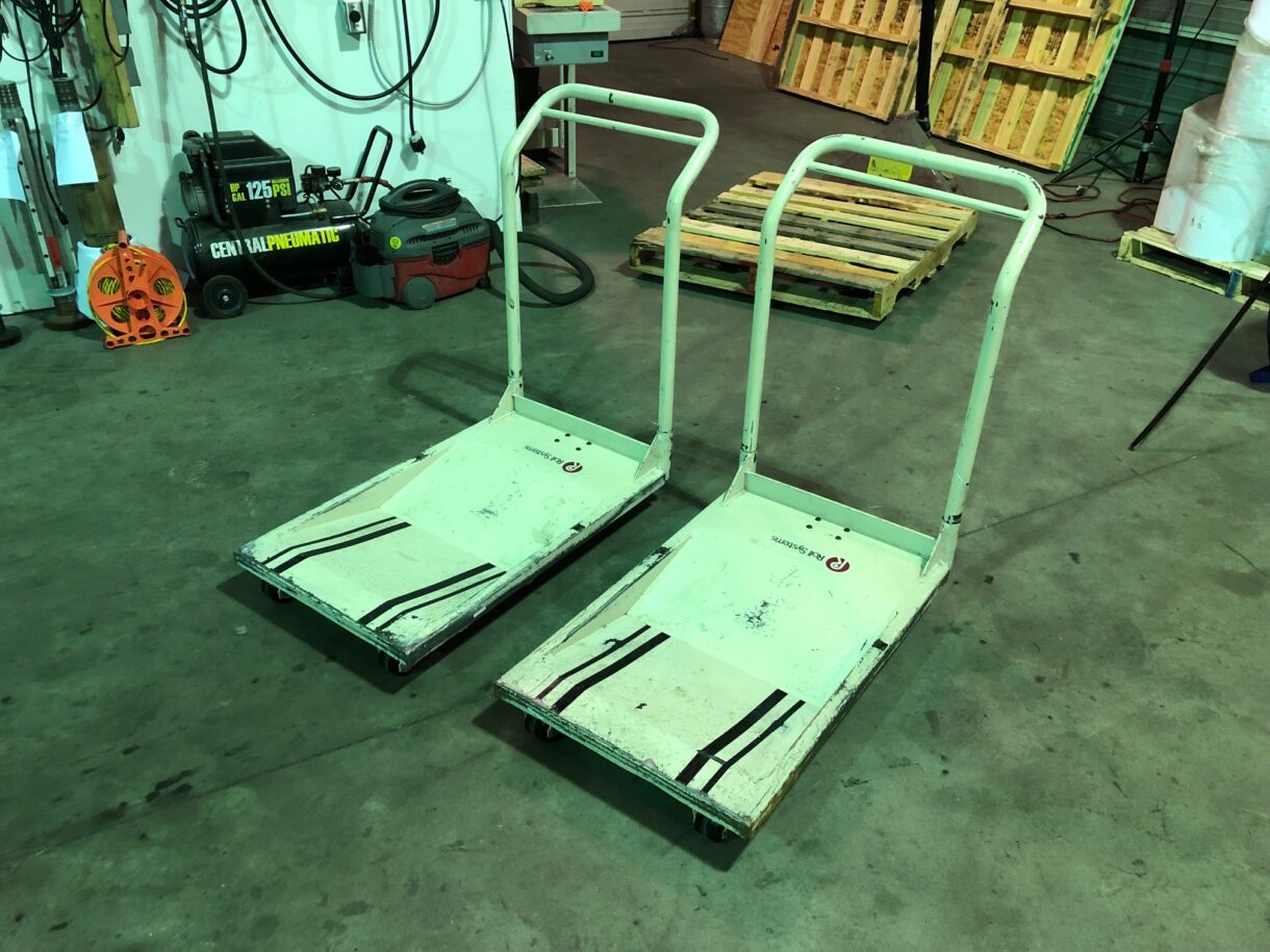 Used Lasermax Roll Systems Roll Cart 18 paper roll carts lined up before cleaning